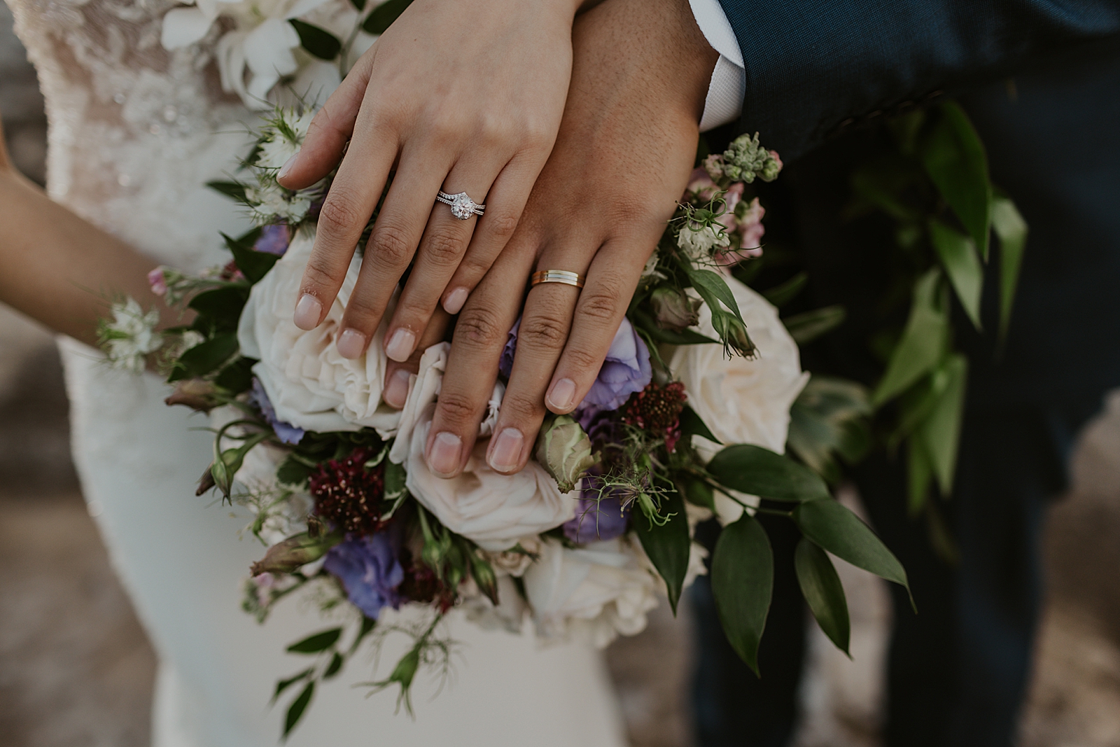 Closeup of Bride and Groom's hands with wedding bands