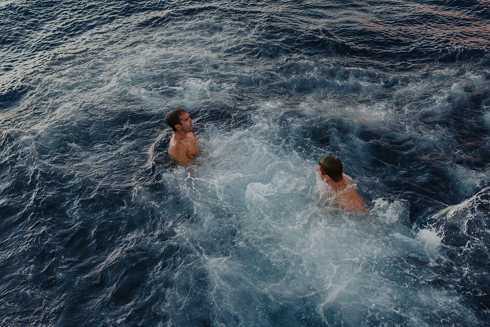 Couple of guys swimming in the ocean
